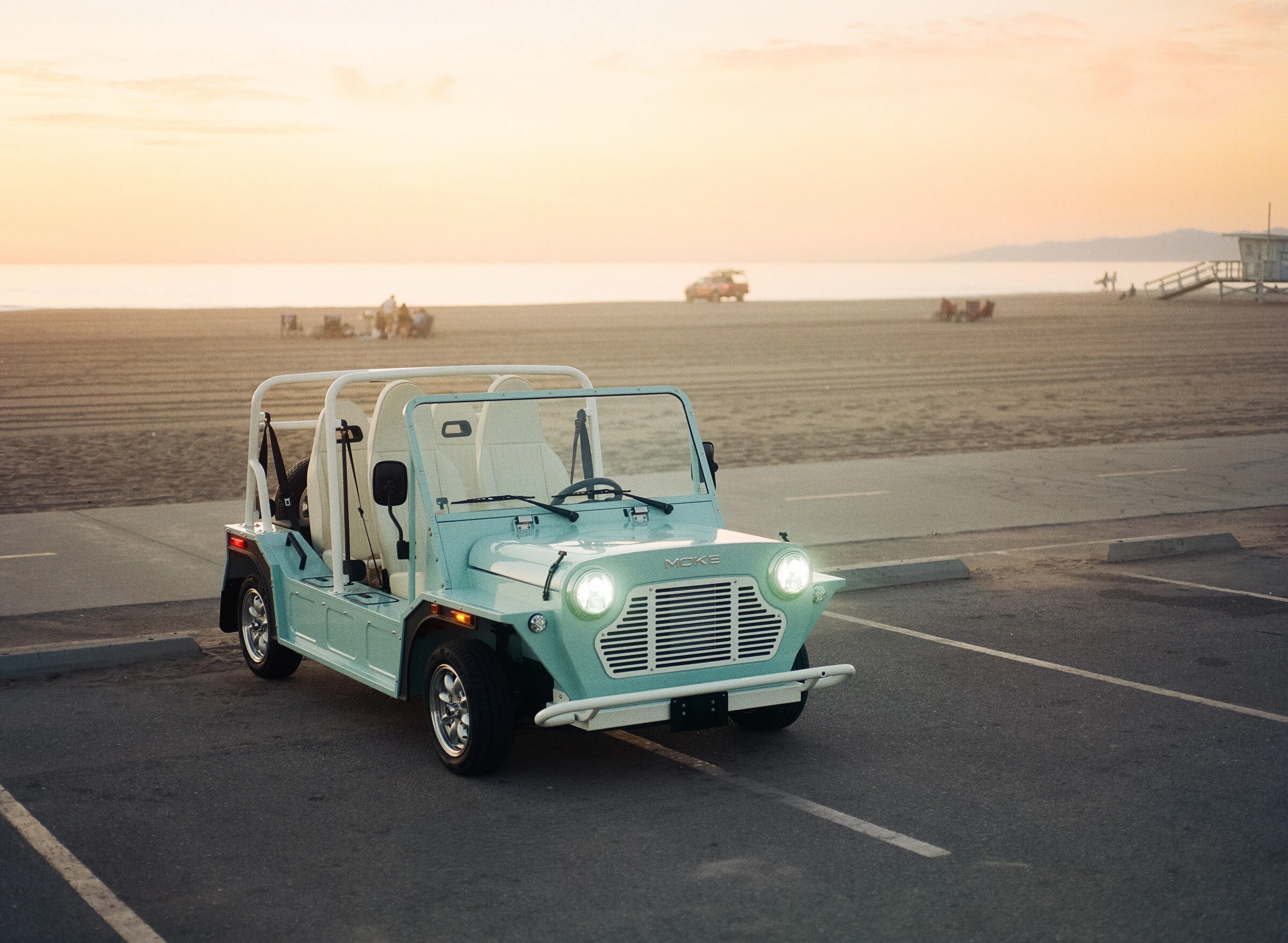 Blue Moke beside the California coast at sunset