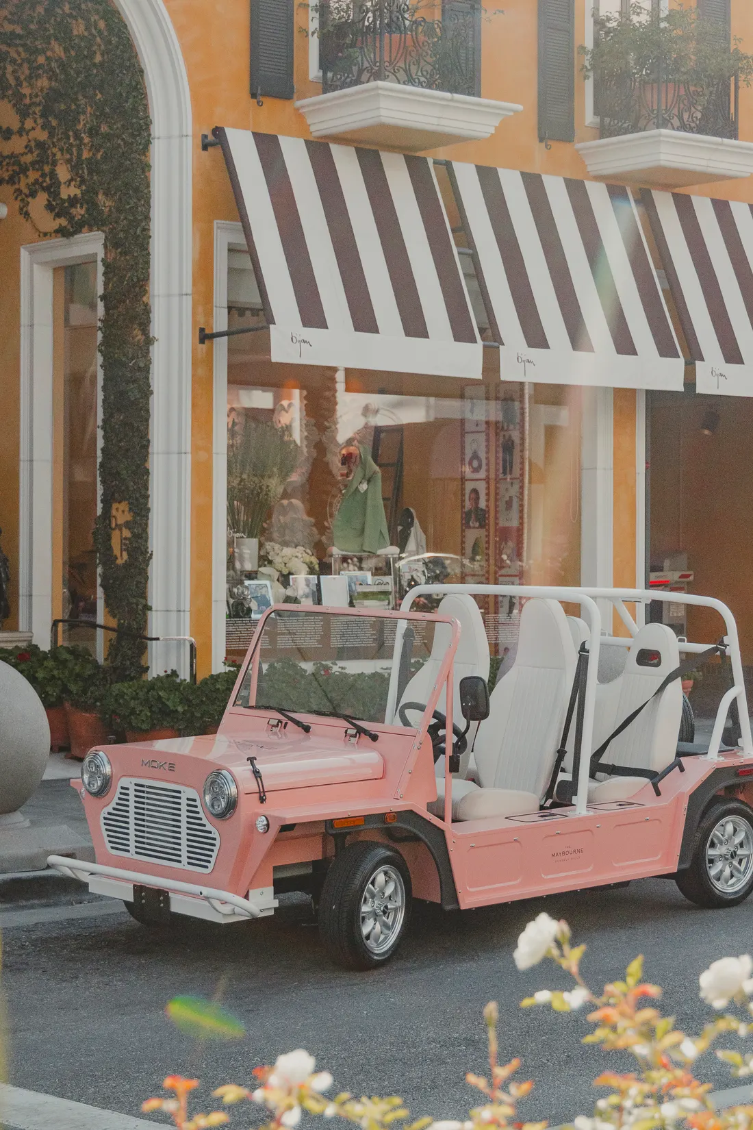 Maybel parked outside Bijan on Rodeo Drive under a striped awning