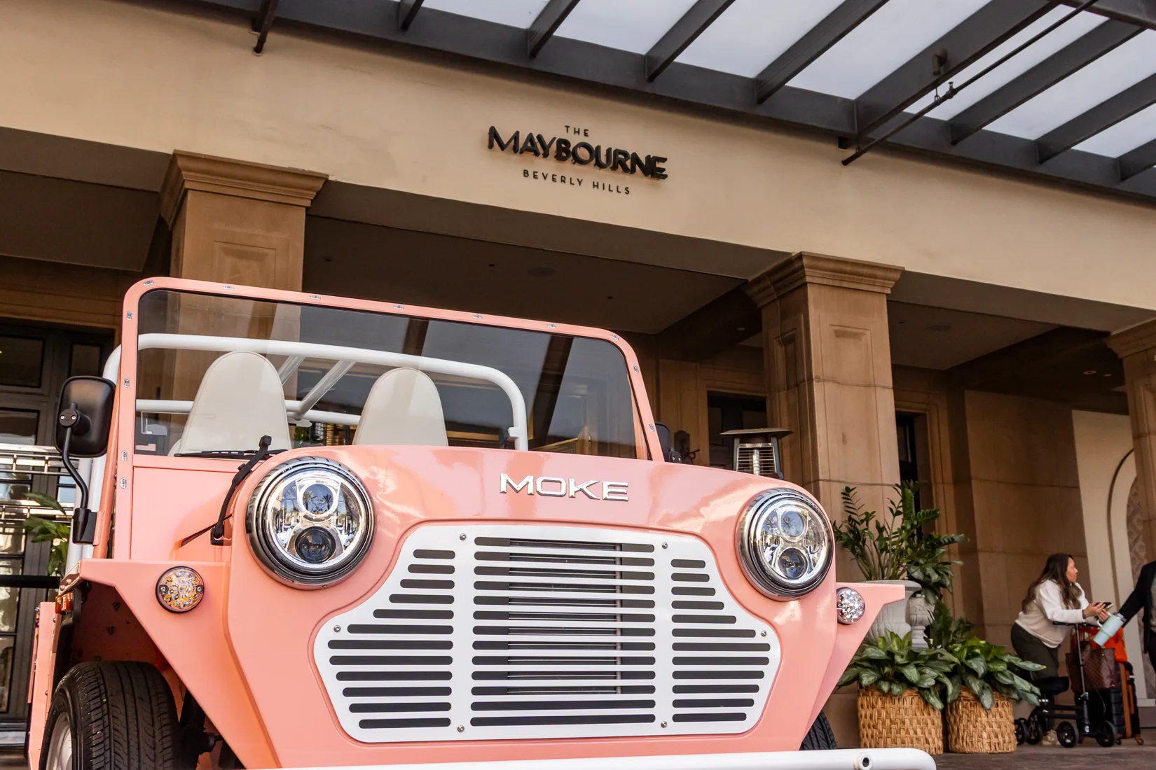 Maybel — the blush-pink Moke — at the entrance of The Maybourne Beverly Hills