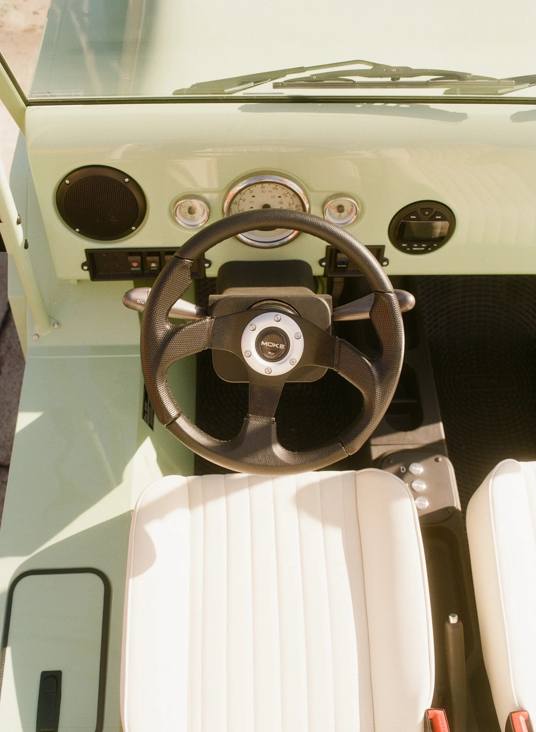 View over the wheel of an open-air electric Moke