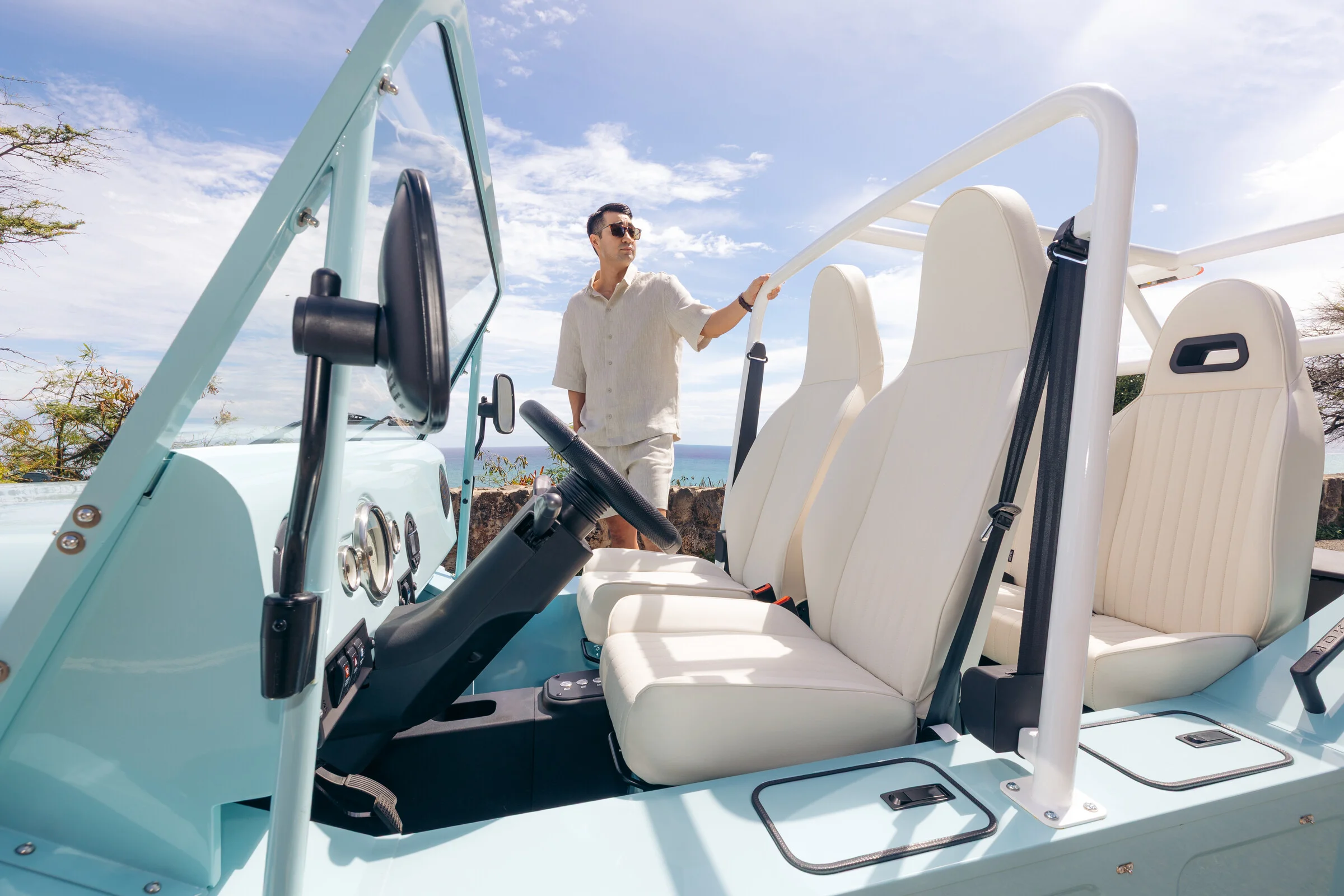 Cream seats in an open-air blue Moke