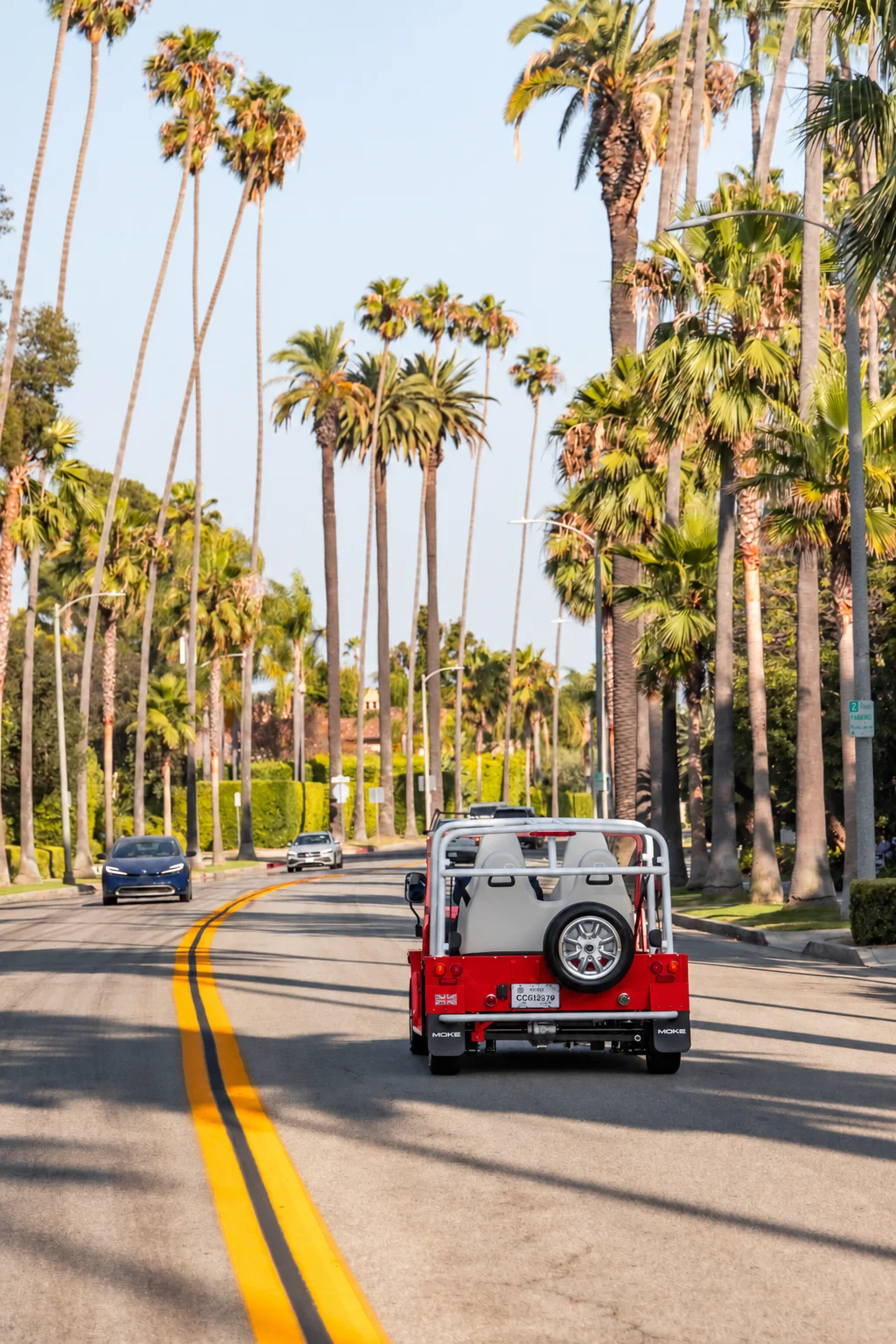 A red Moke beneath Beverly Hills palm trees