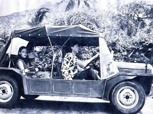 Early Mini Moke with passengers on a tropical road, scanned vintage photograph